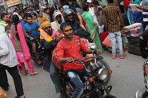 India, Uttar Pradesh, Varanasi, Motorcyclist on Dashashwamedh Ghat Road.
