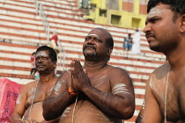 India, Uttar Pradesh, Varanasi, A bereaved man praying at Kedar Ghat.