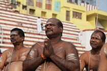 India, Uttar Pradesh, Varanasi, A bereaved man praying at Kedar Ghat.