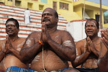 India, Uttar Pradesh, Varanasi, A bereaved man praying at Kedar Ghat.