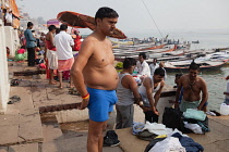 India, Uttar Pradesh, Varanasi, Hindu pilgrim at Dashashwamedh Ghat beside the River Ganges.