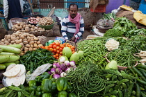 India, Uttar Pradesh, Varanasi, A vegetable vendor.