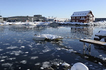 Norway, Lofoten, Svolvaer, Partially frozen inner harbour with floating ice and leisure boats.