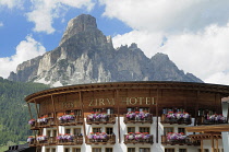 Italy, Trentino Alto Adige, Corvara, hotel with Cunterinesspitzen backdrop.