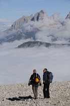 Italy, Trentino Alto Adige, Marmolada, view across to Sasso Lungo mountain range with hikers.