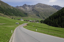 Italy, Trentino Alto Adige, Valle Lunga, valley views & road with Otztal Alps in distance.