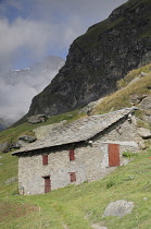Italy, Piedmont, Val di Viu, farm buildings at Lago di Malciaussia.