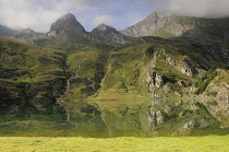 Italy, Piedmont, Val di Viu, Lago di Malciaussia with landscape reflected in water.