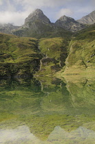 Italy, Piedmont, Val di Viu, Lago di Malciaussia with landscape reflected in water.