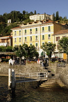 Italy, Lombardy, Bellagio, view of lakeside at Bellagio in evening sun with small pier.