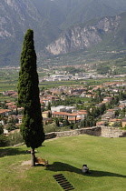 Italy, Trentinto Alto Adige, Lake Garda, Arco, castle grounds with couple taking shade.