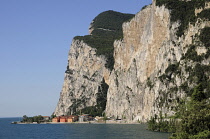 Italy, Lombardy, Lake Garda, steep cliffs fall into lake at Campione del Garda.