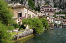 Italy, Lombardy, Lake Garda, Limone Rivera, view along waterfront with Limonaia in distance, Lemon castle.