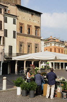 Italy, Lombardy, Mantova, Piazza delle Erbe with flower stall.