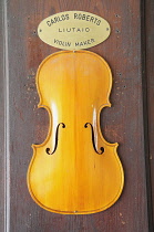 Italy, Lombardy, Cremona, Violin maker's door detail.