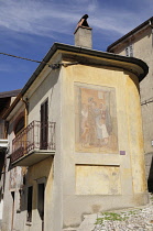 Italy, Piemonte, Arcumeggia, cobbled streets with walls adorned with paintings.