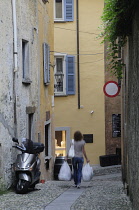 Italy, Piemonte, Lake Maggiore, Cannobio, street scene with shopper.