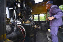 Transport, Rail, Steam Train, Watercress Line engine fireman loading the boiler with coal.