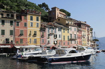 Italy, Liguria, Portofino, waterside houses with boats in the bay.