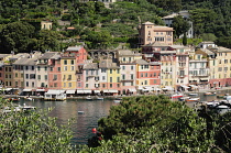 Italy, Liguria, Portofino, waterside view of colourful houses & bay.
