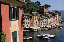 Italy, Liguria, Portofino, waterside view of colourful houses & bay.