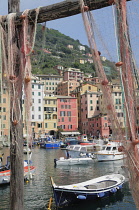 Italy, Liguria, Camogli, harbour with fishing boats & nets.