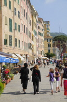 Italy, Liguria, Camogli, family walking along the esplanade at Camogli.