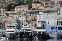 Italy, Liguria, Genoa, port views with boats, Aquarium & city backdrop.