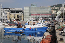 Italy, Liguria, Genoa, Porto Antico, Galata Museo Del Mare with fishing boats.