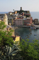 Italy, Liguria, Cinque Terre, Vernazza, view into the harbour with church & Belforte castle.