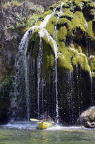 France, Lozere, St Chely du Tarn, Gorges du Tarn, Pair of canoeists paddling through the waterfall Cascade.