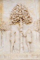 Italy, Lombardy, Pavia, Adam & Eve relief detail on facade of Church of Our Lady of Graces.