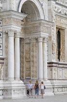 Italy, Lombardy, Pavia, group entering Church of Our Lady of Graces, Certosa di Pavia.