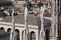 Italy, Lombardy, Milan, Duomo spires with statues and city views.
