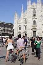 Italy, Lombardy, Milan, cyclists & crowd in the Piazza Duomo.