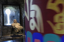 Italy, Trentino Alto Adige, Bolzano, Firmian, Messner Mountain Museum, seated Buddha with Prayer wheel, The North Tower exhibit.