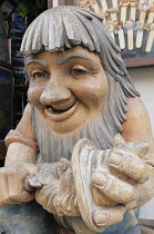 Italy, Trentino Alto Adige, Ortisei, wood carved troll outside craft shop.