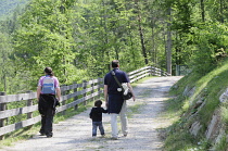 Italy,Trentino; Alto Adige, Adamello Brenta Natural Park, Spormaggiore Visitor Centre, family wandering through the park.