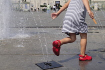 Italy, Piedmont, Turin, child playing in the fountain on Piazza Castello.
