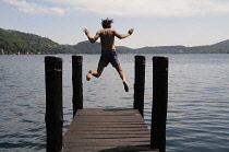 Italy, Lombardy, Lake Orta, jumping into the lake at Orta San Giulio.