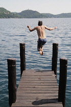 Italy, Lombardy, Lake Orta, jumping into the lake at Orta San Giulio.