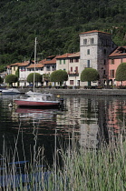 Italy, Lombardy, Lake Orta, Pella, waterfront buildings and moored boats.