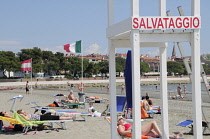 Italy, Veneto Friuli, Grado, Spiaggia Costa Azzurra, lifeguard post with sunbathers.