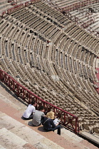 Italy, Veneto, Verona, Interior of Arena with group seated.
