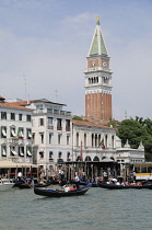 Italy, Veneto, Venice, gondolas leaving from Piazza San Marco with campanile indistance.