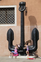 Italy, Veneto, Venice, Museo Storico Navale, anchor with children playing.