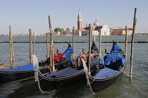 Italy, Veneto, Venice, gondolas along waterside at Il Molo with view across to San Giorgio Maggiore.