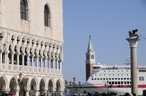 Italy, Veneto, Venice, Palazzo Ducale with cruise ship passing Piazza San Marco.