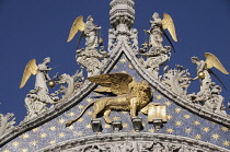 Italy, Veneto, Venice, Gold Lion of St Mark, Basilica San Marco facade.