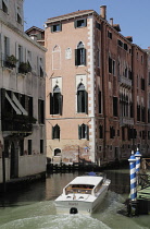 Italy, Veneto, Venice, canal scene with taxi boat.